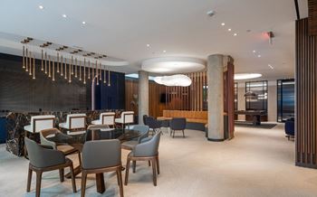 a dining room with a long table and chairs and a large pillar